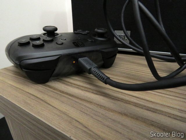 Nintendo Switch Pro Controller., conectado ao dock do Nintendo Switch.