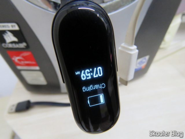 Xiaomi Mi Band 3 Original, em funcionamento, sendo carregada.